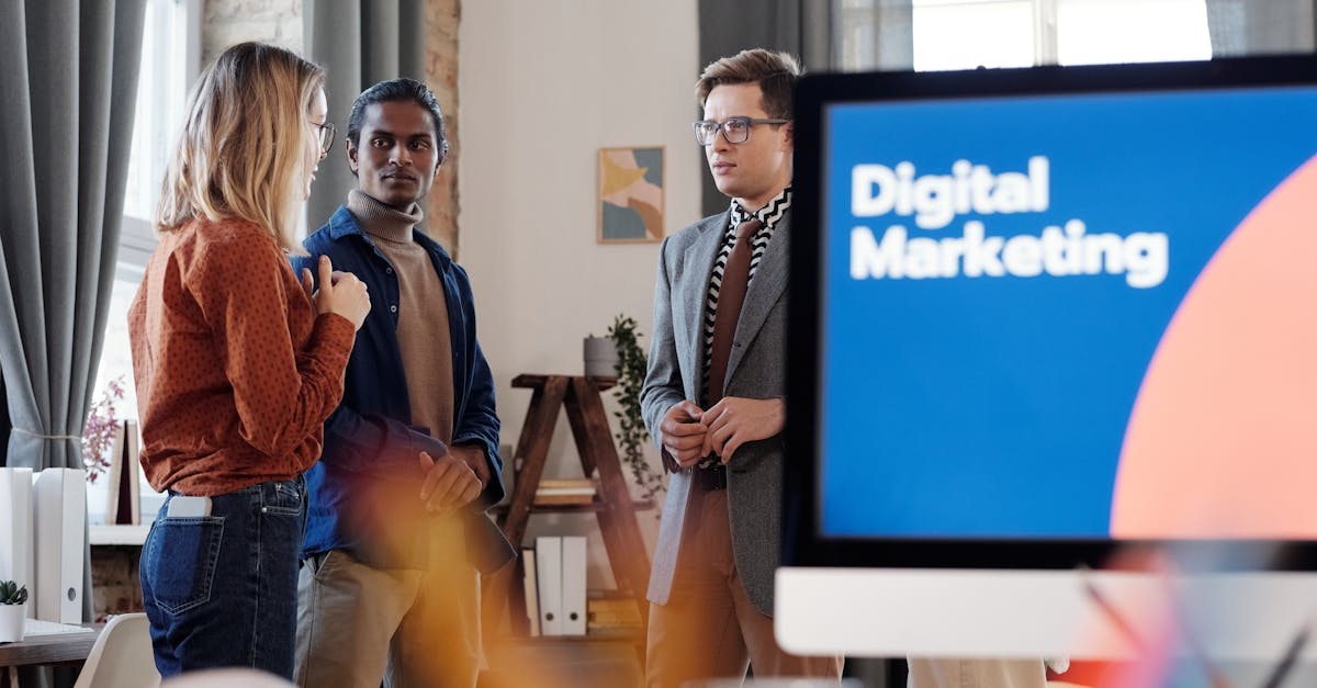 Group of colleagues discussing digital marketing strategies in an office setting.